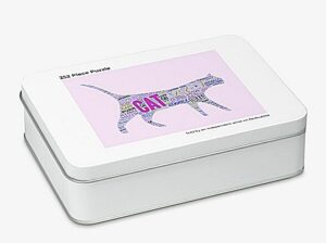 A white tin containing a 252 piece jigsaw puzzle comprising a piece of word art of a acat on a pink background. The words include blep and purr